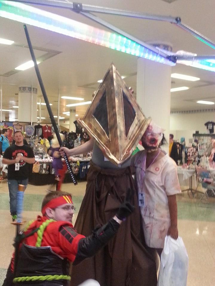 Cosplay photo of a pyramid head cosplay holding a sword